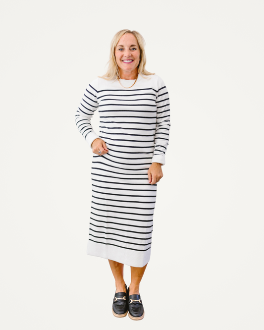 A woman models a chic striped dress