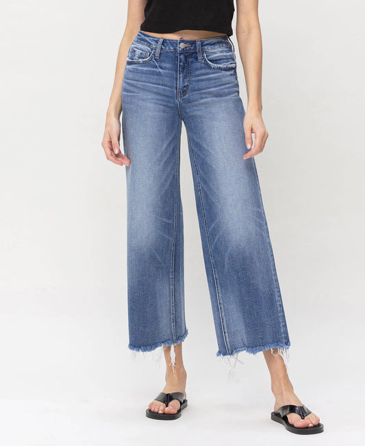 High-waisted denim jeans with frayed hems, great for layering with HALFTEE Layering Fashions.