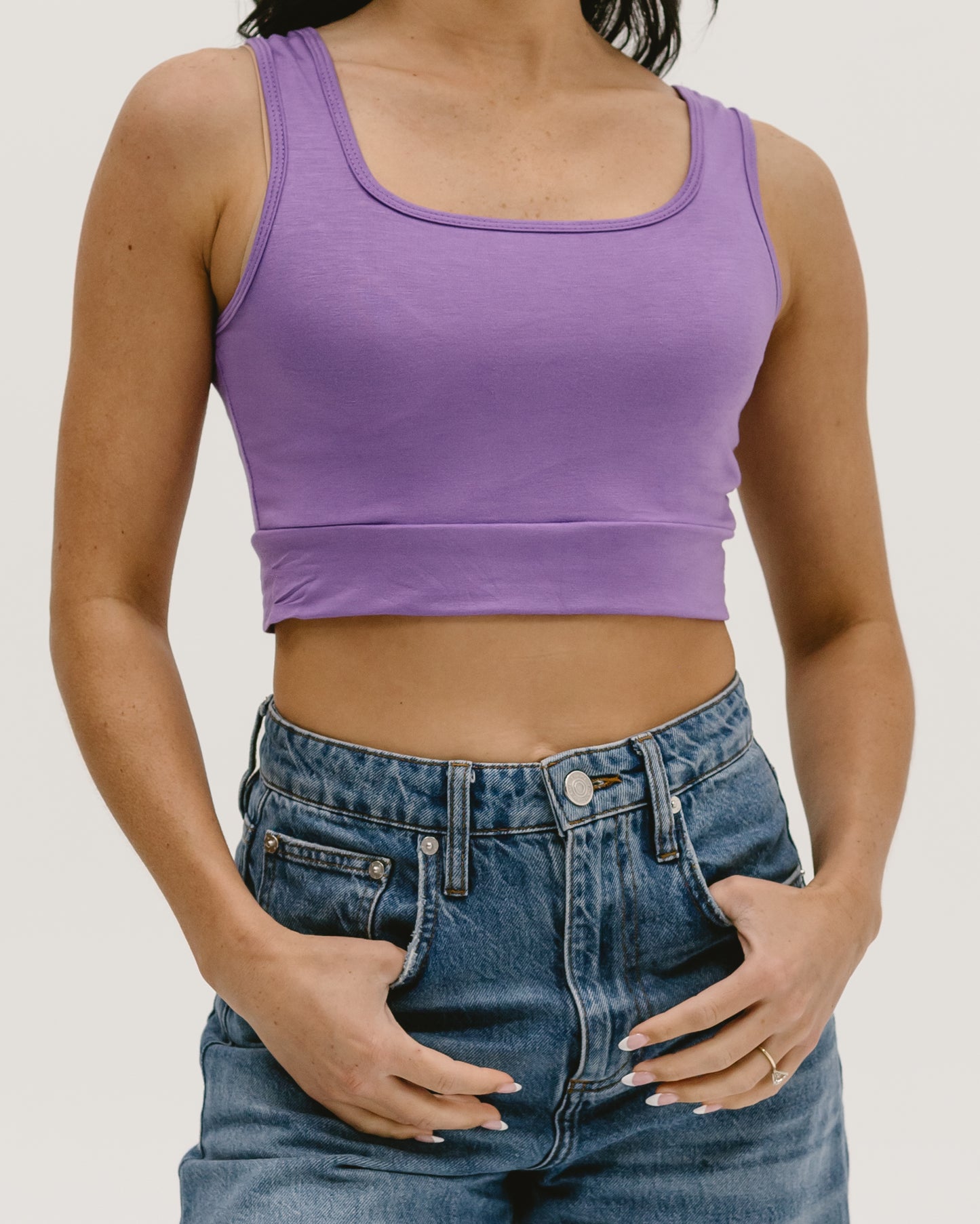 Woman wearing Halftee crop top and jeans, back view