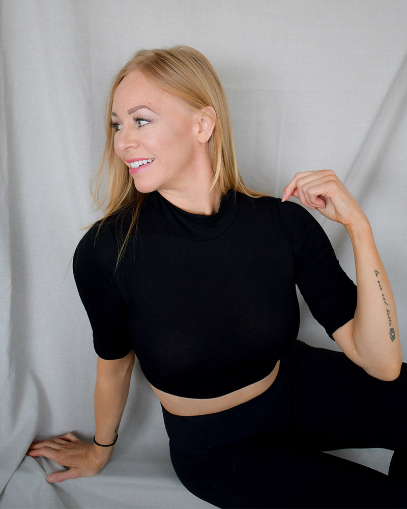 Black crop top made from soft, breathable fabric. Mock Elbow Sleeve Halftee.