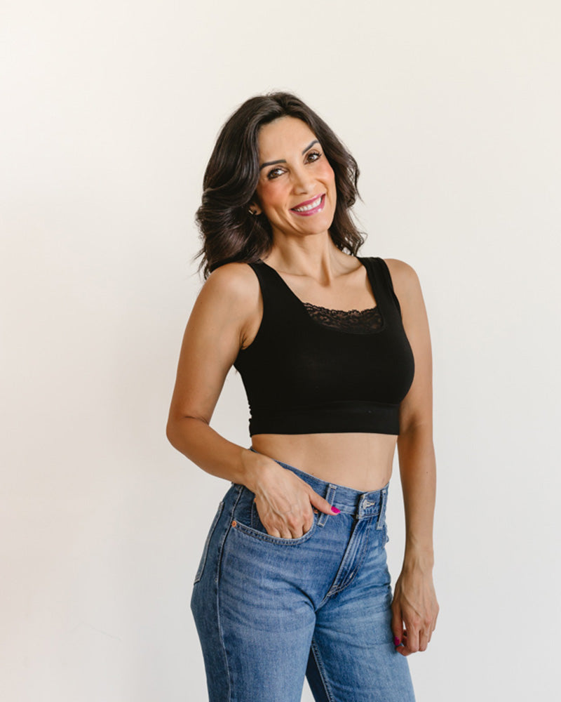 woman in a black crop top and jeans, wearing a Peekaboo Short Sleeve Halftee with lace inset.