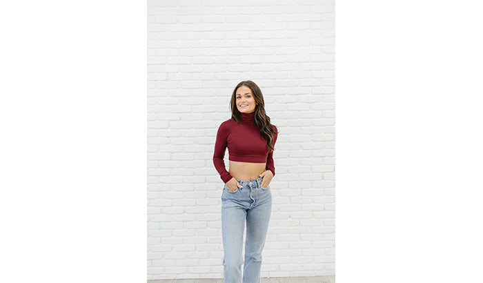 A burgundy turtle neck crop top, perfect for seasonal outfits, featuring a stylish half shirt design.