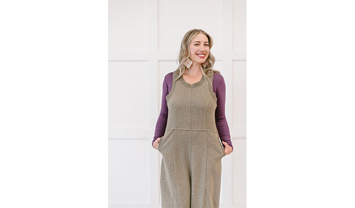 A khaki overall jumpsuit featuring long sleeves, designed for layering and modesty, suitable for various occasions.