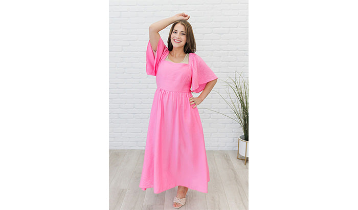 A long sleeve pink dress featuring a square neckline and flared hem, ideal for layering in a casual wardrobe.