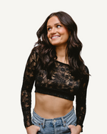 A woman wearing a Full Lace Tank crop top and jeans, showcasing a trendy and casual outfit.