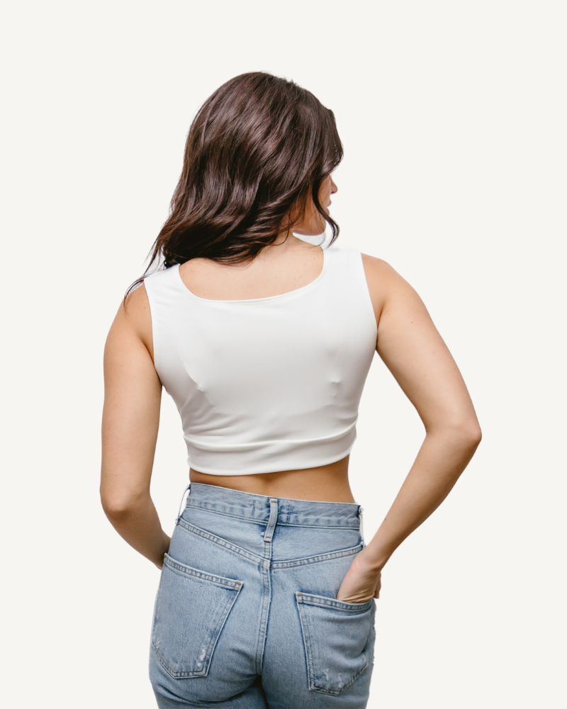 A woman wearing an Elegant Tank, seen from the back, in a white crop top.