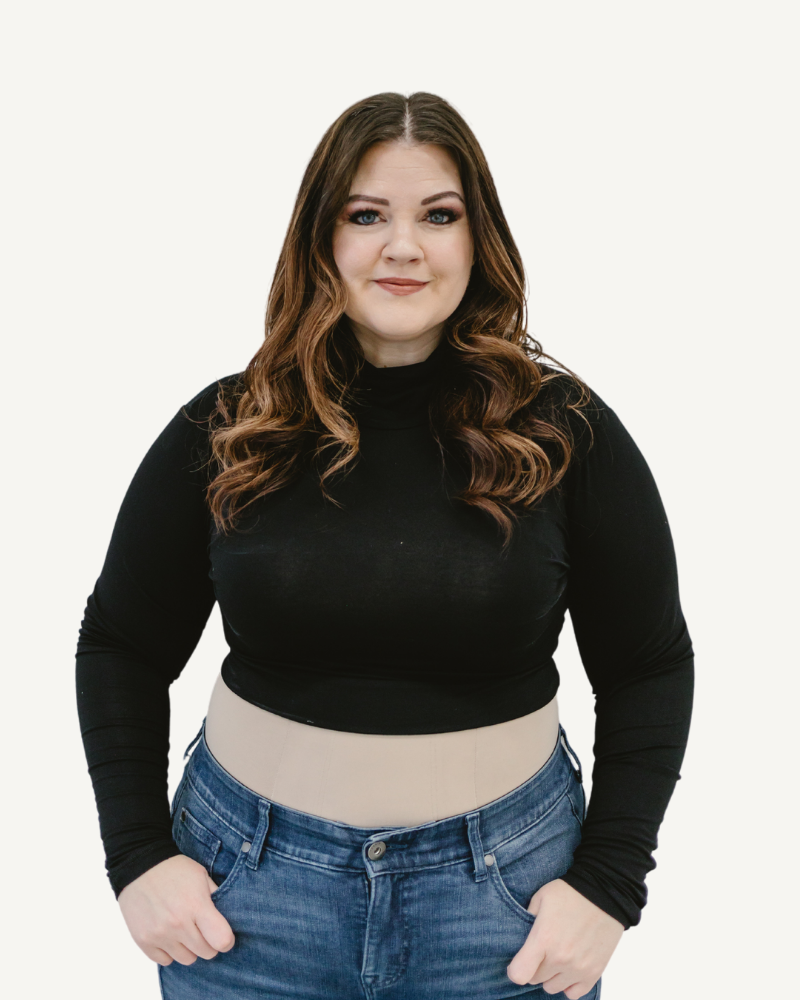 A  plus size woman wearing a black crop top and jeans, with a turtleneck long sleeve made of spandex and rayon blend.