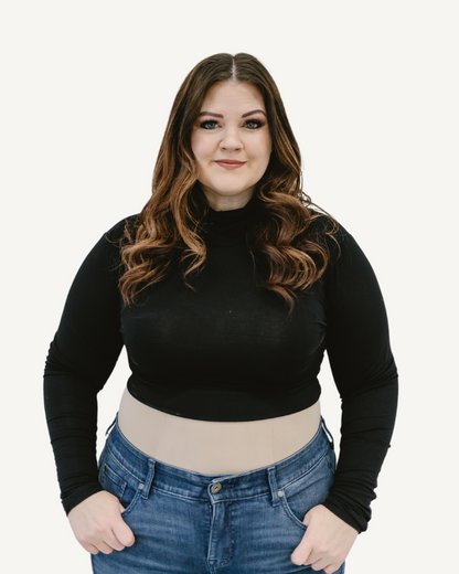 A  plus size woman wearing a black crop top and jeans, with a turtleneck long sleeve made of spandex and rayon blend.