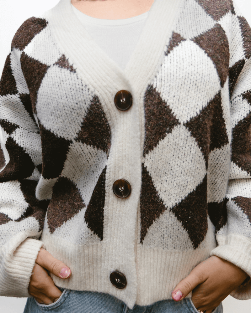 Black and white checkered pattern cardigan sweater, featuring an argyle design.