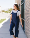 A navy blue loose overall jumpsuit made of solid fabric.