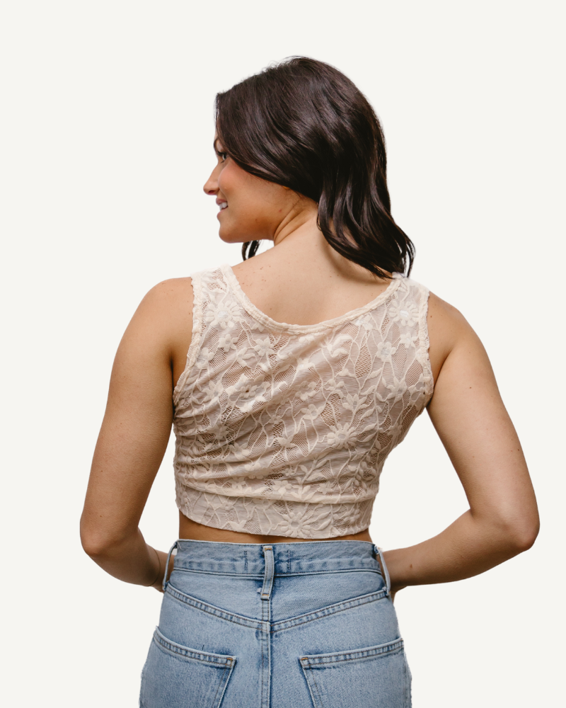 A woman wearing a Full Lace Tank crop top and jeans, showcasing a trendy and casual outfit.