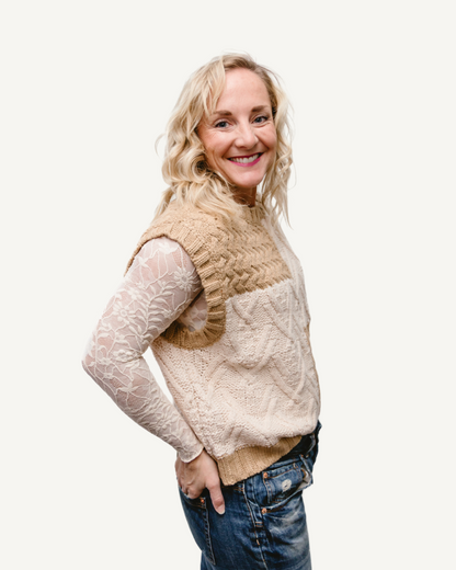 A woman in a black and white sweater and jeans, wearing a Full Lace Tank.