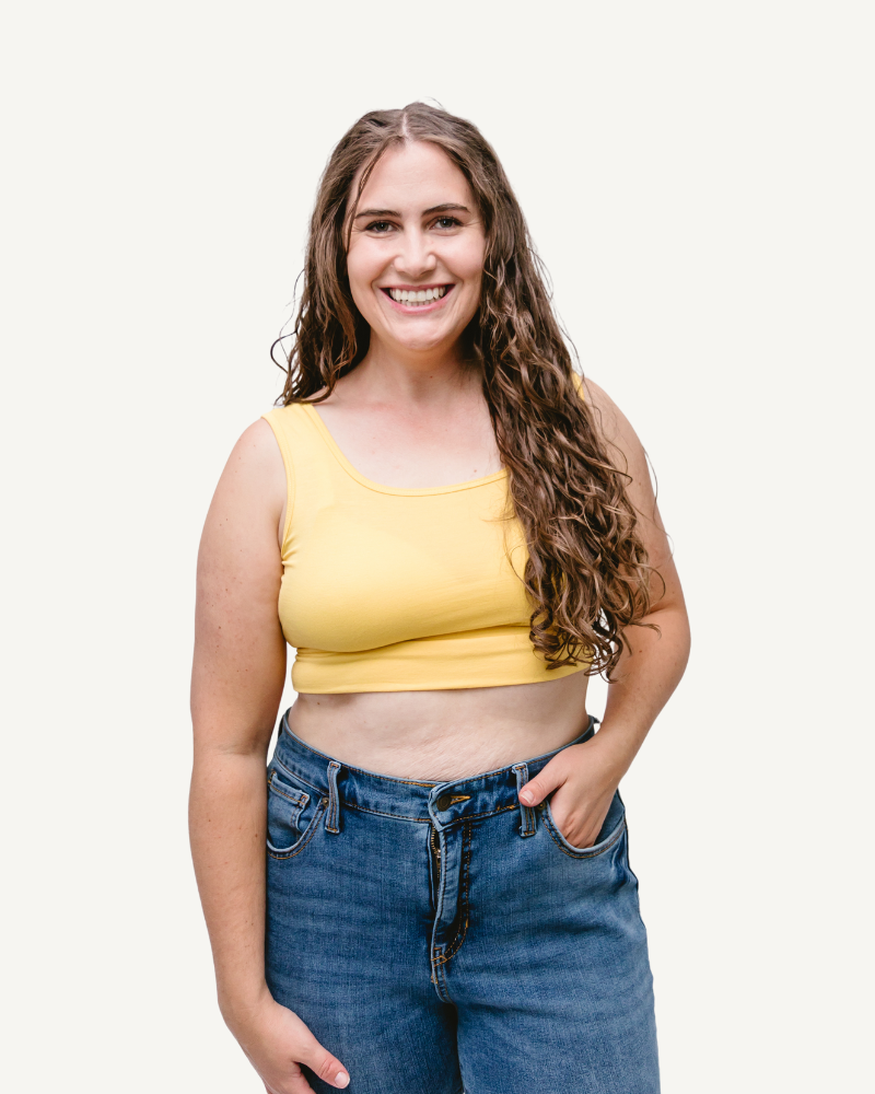 curly woman in a yellow sleeves halftee and blue jeans
