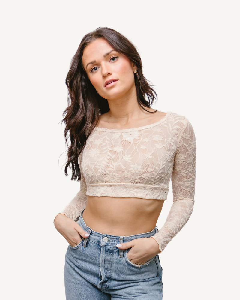 A woman wearing a Full Lace Tank crop top and jeans, showcasing a trendy and casual outfit.