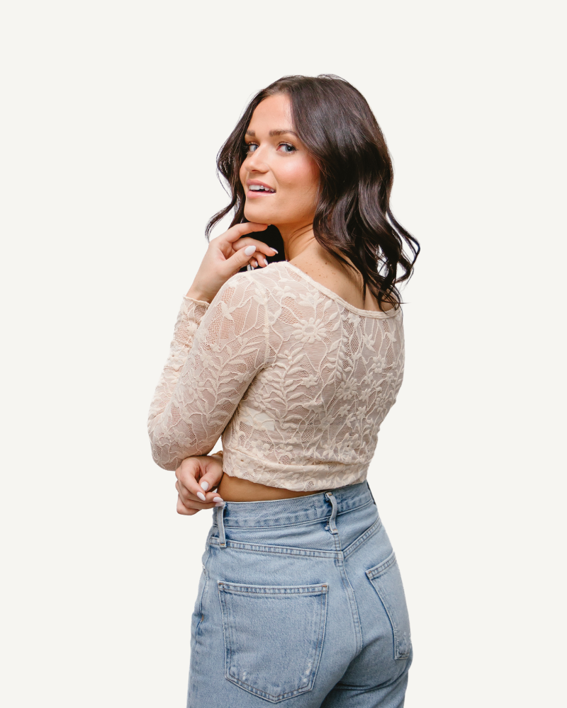 A woman wearing a Full Lace Tank crop top and jeans, showcasing a trendy and casual outfit.