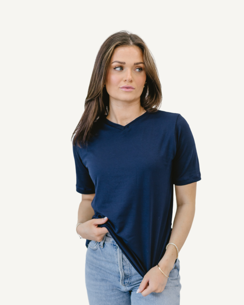  Woman in blue shirt and jeans, standing confidently. Favorite Tee.