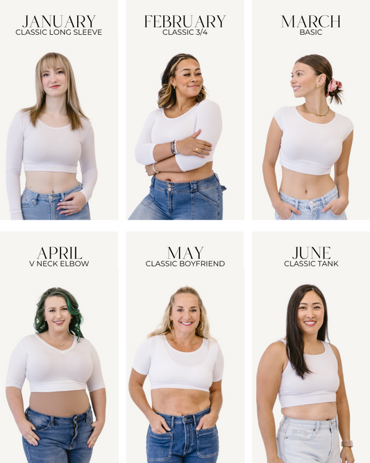 A diverse group of women in fresh white shirts and jeans posing for a photo.