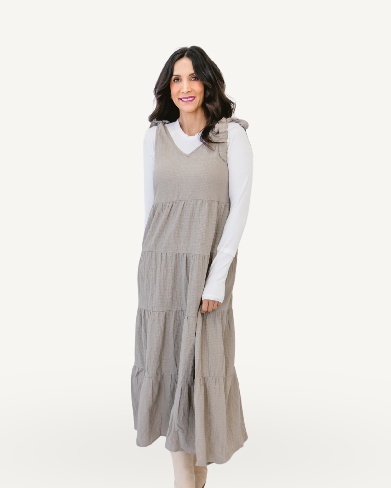 A ribbed knit maxi dress in taupe with tiered design, perfect for a stylish and elegant look.