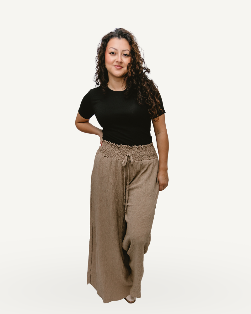 Woman in black shirt and brown Smocked Waist Wide Leg Pants.