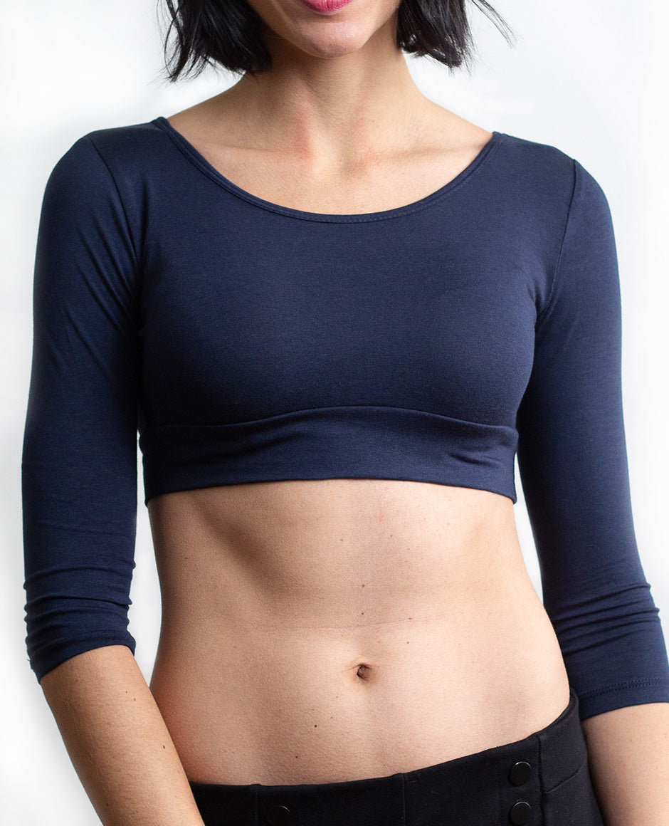 A woman wearing jeans and a crop top, showcasing The Classic navy 3/4 Sleeve Halftee - NEUTRALS.