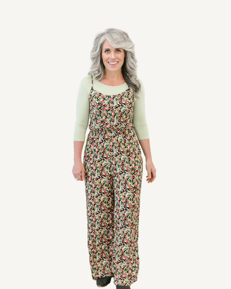 A woman models floral print overalls