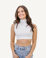 A girl wearing a cropped top made from soft, stretchy fabric, showcasing comfort and style in her casual outfit.