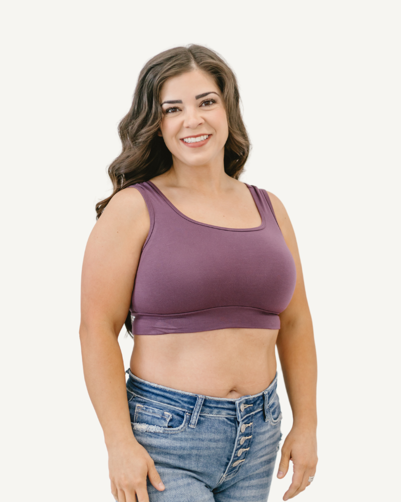  A woman dressed in a purple bra top and jeans 