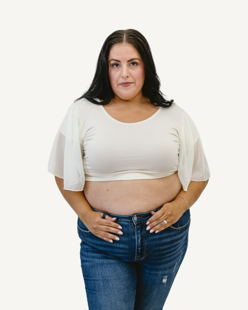 A plus size woman in a white top and jeans, wearing a Waterfall Sleeved Halftee.