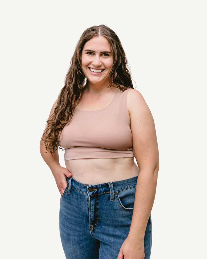 A woman wearing an Elegant Tank, seen from the back, in a taupe crop top.