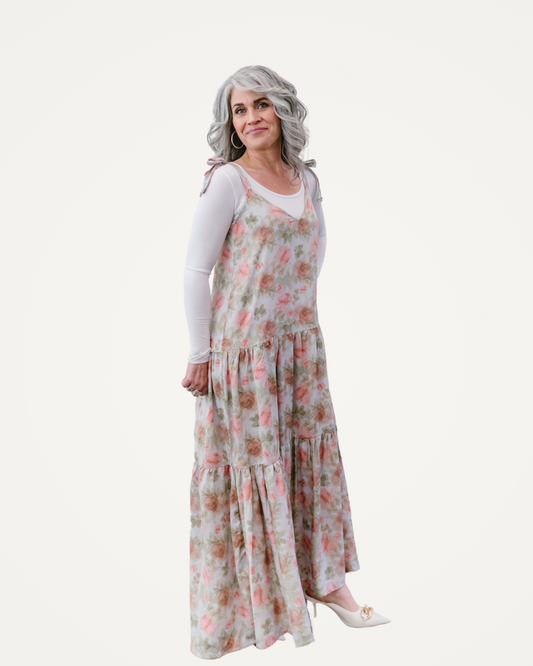  A woman in a floral dress poses gracefully