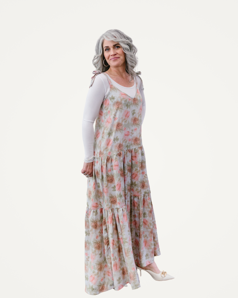  A woman in a floral dress poses gracefully