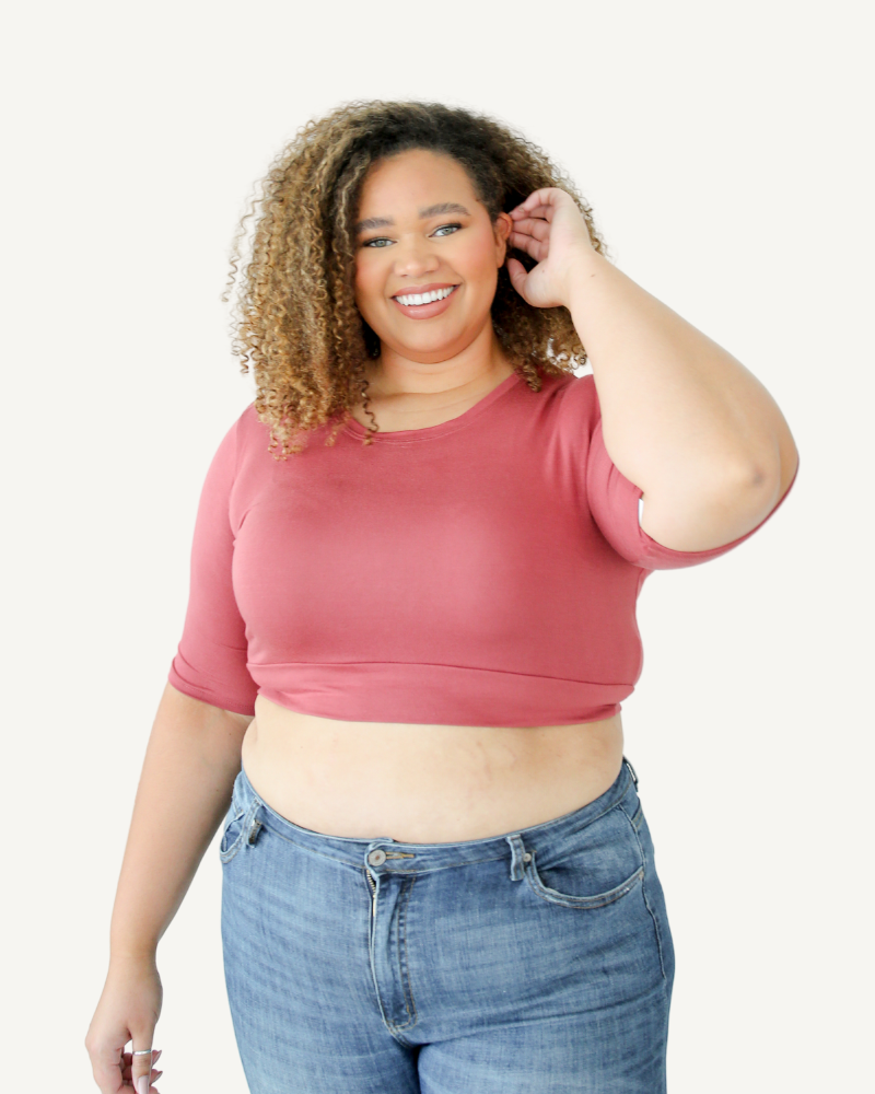 Woman in pink  crop top and jeans. Discontinued Basic Cap Sleeve.