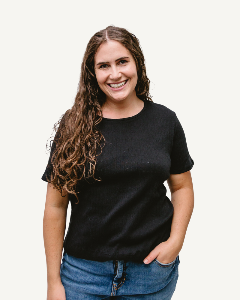 A woman wearing a black t-shirt and jeans.