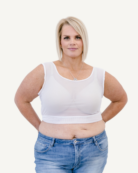 Woman in white mesh tank top and black leggings.