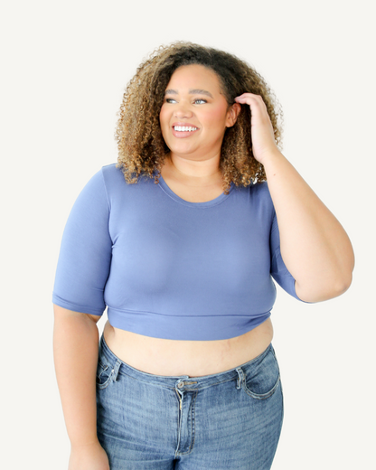 Woman in blue crop top and jeans. Discontinued Basic Cap Sleeve.