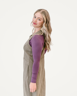 A taupe dress displayed elegantly, showcasing its soft color and flowing design, perfect for various occasions.