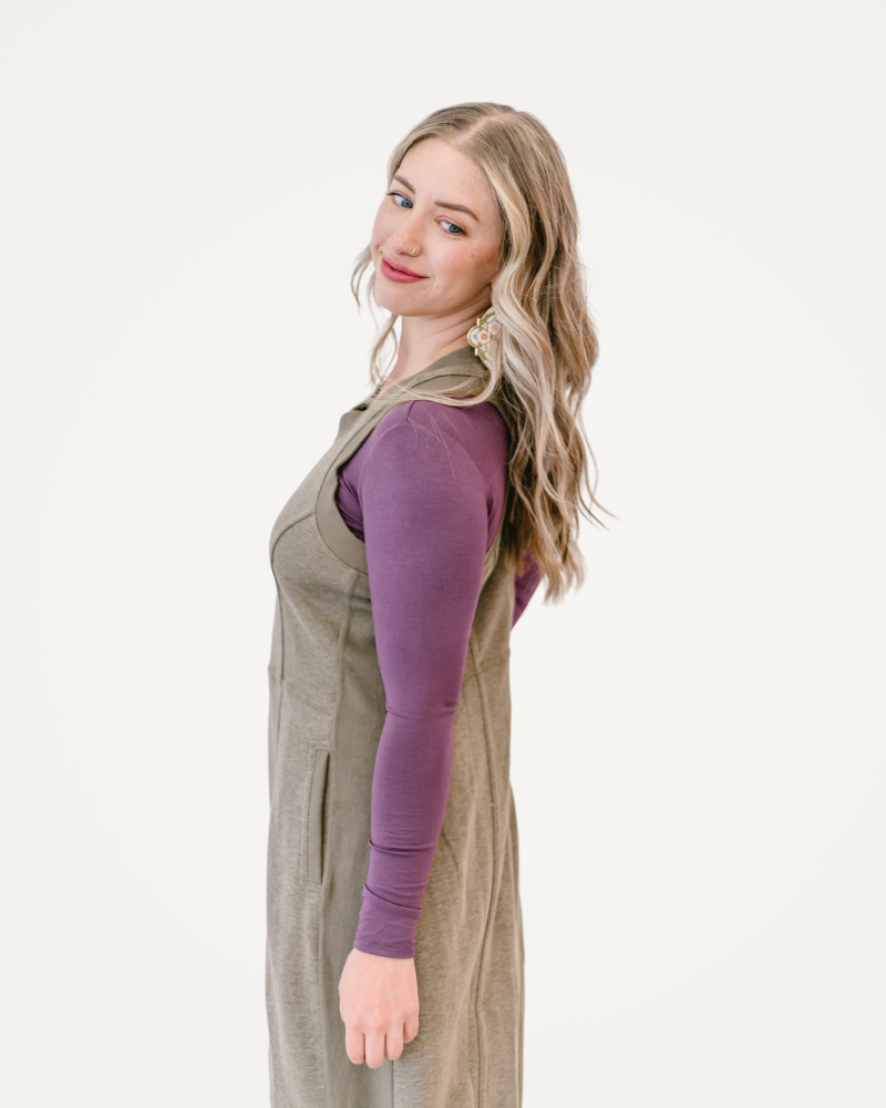 A taupe dress displayed elegantly, showcasing its soft color and flowing design, perfect for various occasions.