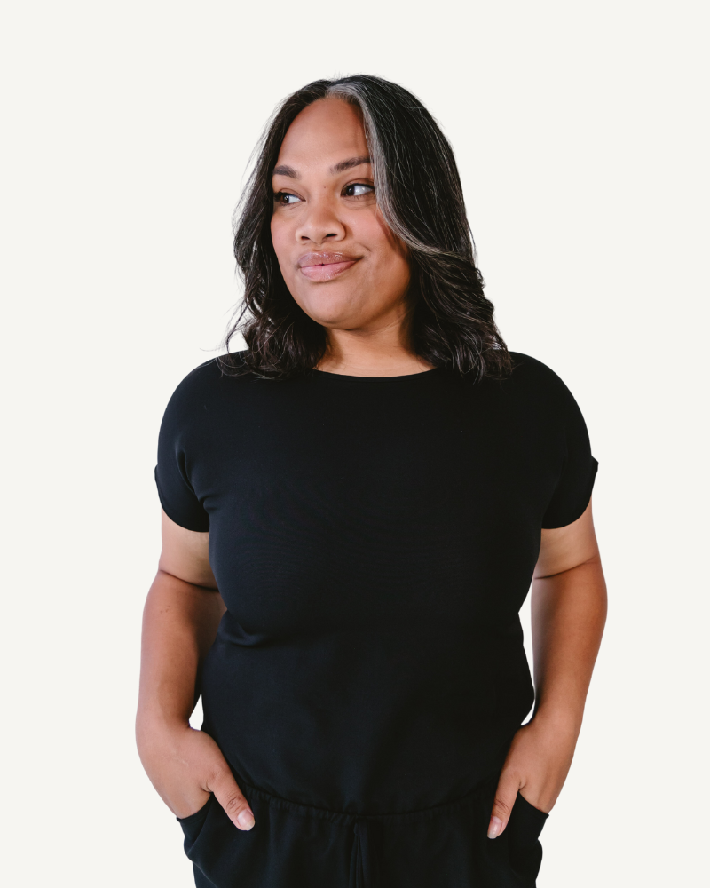 A soft, stretchy black romper made from comfortable fabric.