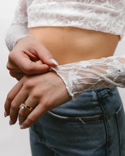 A woman wearing a Full Lace Tank crop top and jeans, showcasing a trendy and casual outfit.