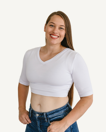 A woman  wearing a white  top with elbow sleeves and a V-neck.