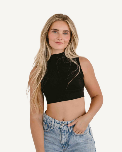 Woman in crop top and jeans, Mock Neck Sleeveless Front.