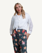 A woman wearing floral print pants.
