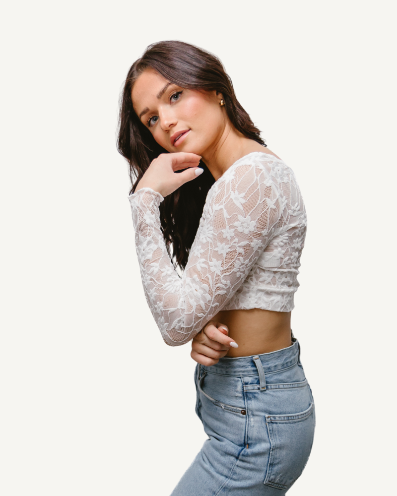 A woman wearing a Full Lace Tank crop top and jeans, showcasing a trendy and casual outfit.