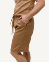 A soft, stretchy brown romper made from comfortable fabric.