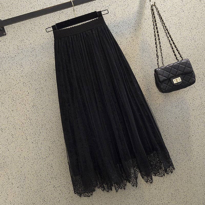 A black skirt and a purse displayed elegantly on a wall, showcasing HALFTTEE Layering Fashions' stylish offerings.