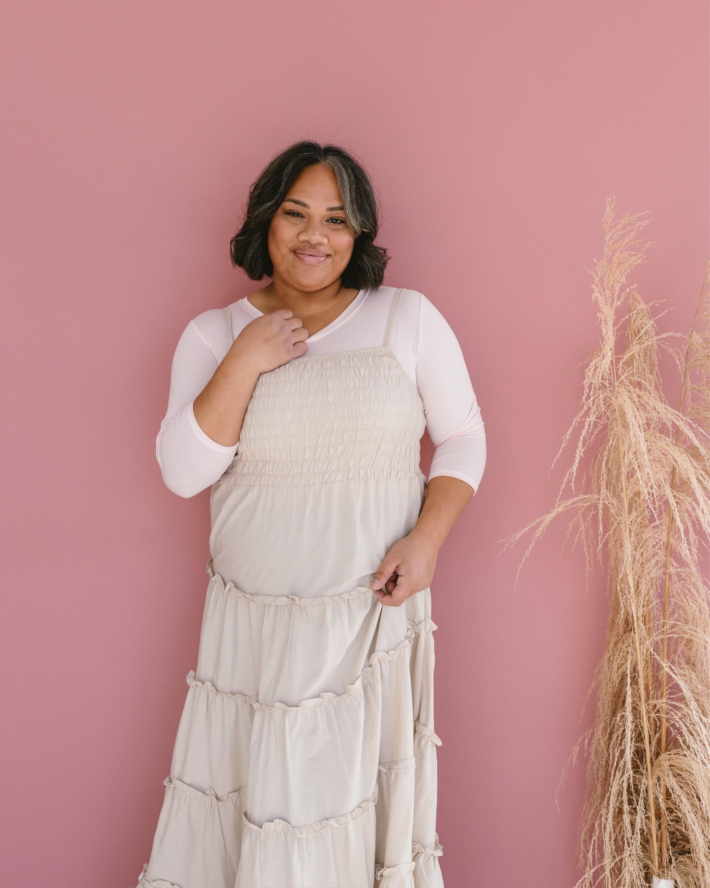 A woman in a white crop top and jeans, wearing a Crew Neck 3/4 Sleeve Halftee.