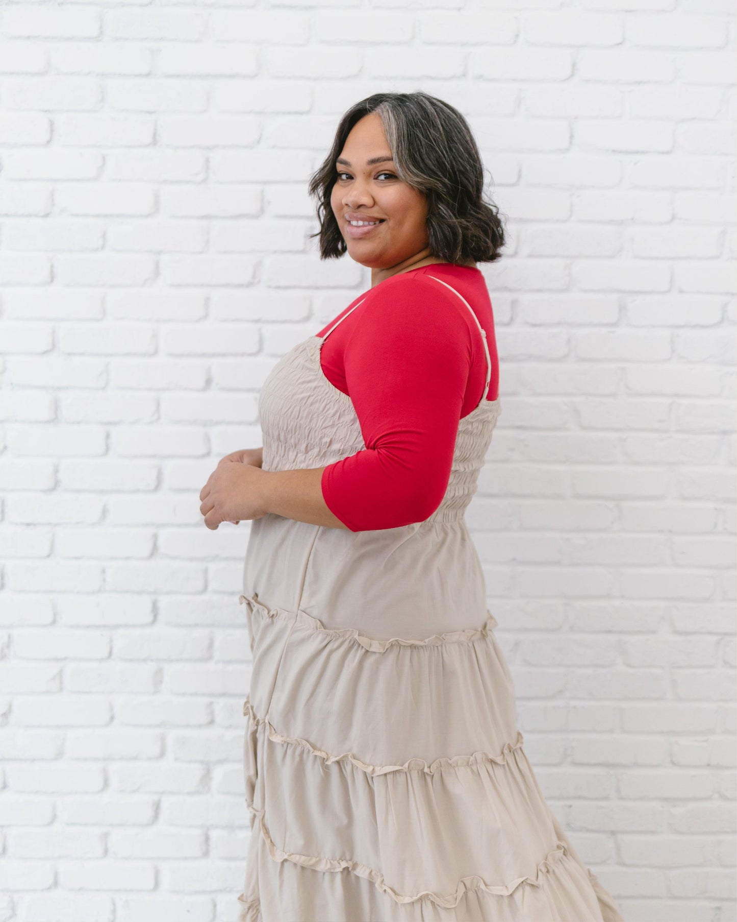 A woman in a red crop top and jeans, wearing a Crew Neck 3/4 Sleeve Halftee.