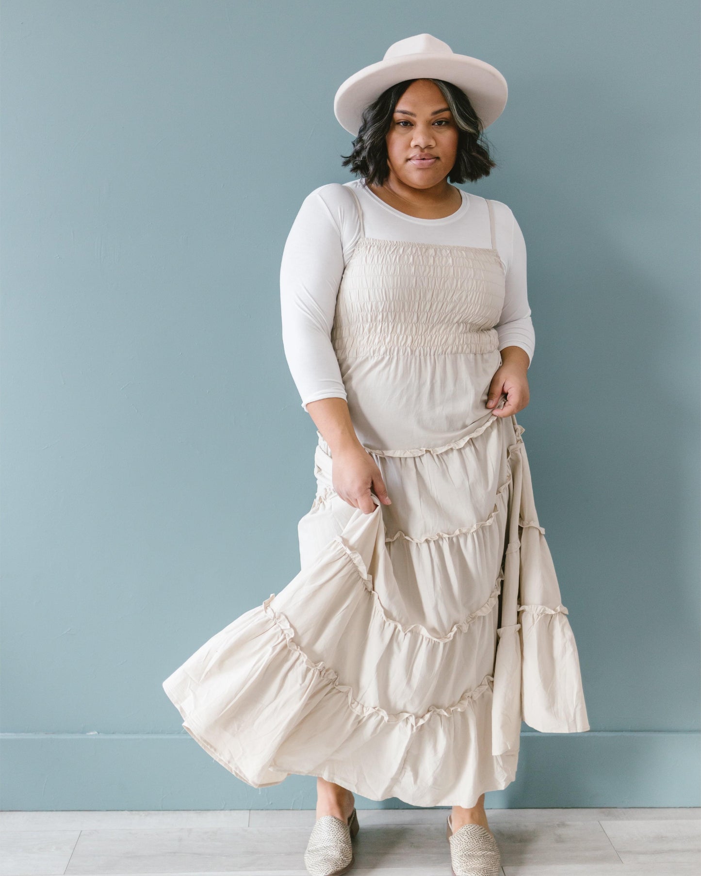 A woman in a white crop top and jeans, wearing a Crew Neck 3/4 Sleeve Halftee.