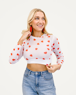 HALFTEE Layering Fashions presents a white crop top adorned with a red heart print, ideal for fashionable layering.