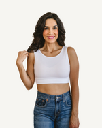 Woman in white crop top and jeans, wearing Classic Wide Strap Tank Halftee.